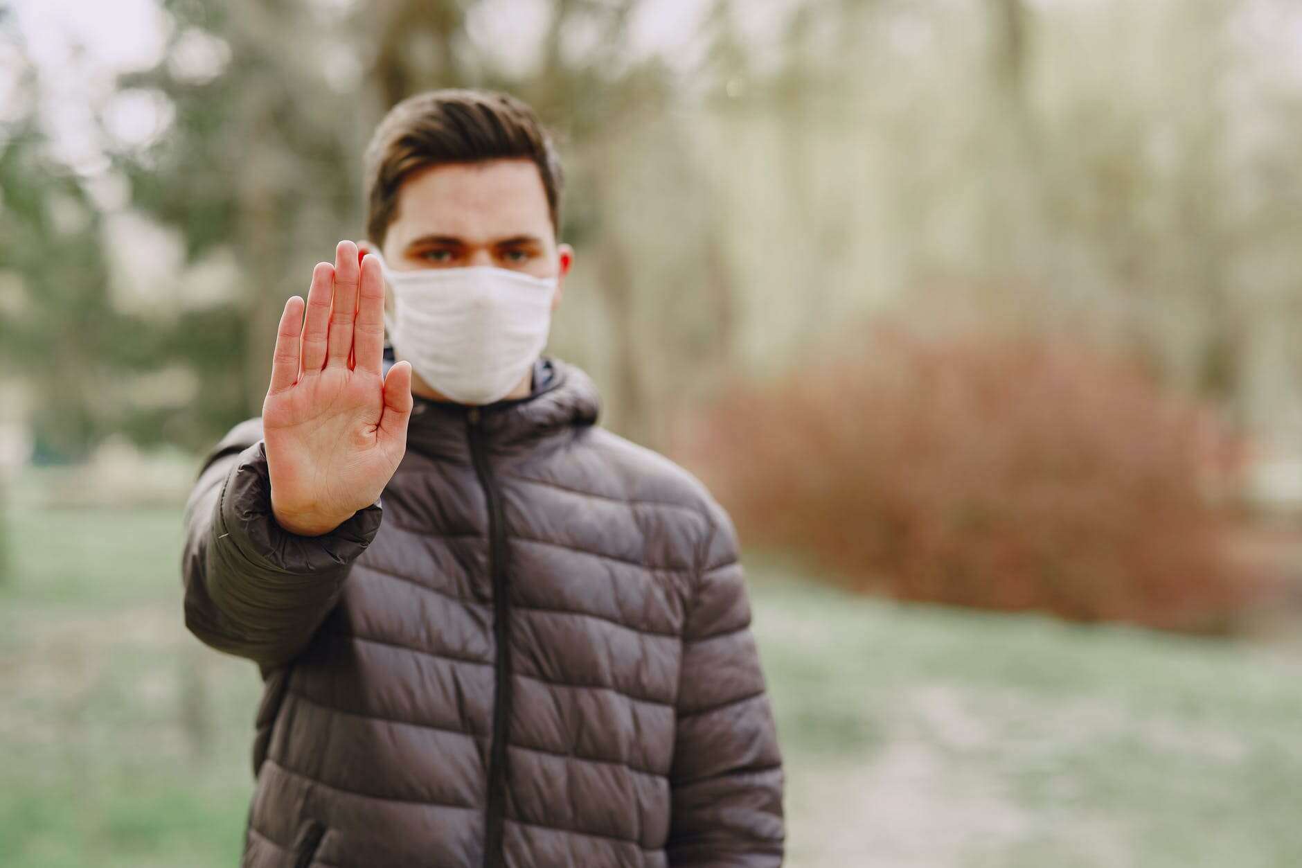 Man With Mask Holding Out Hand