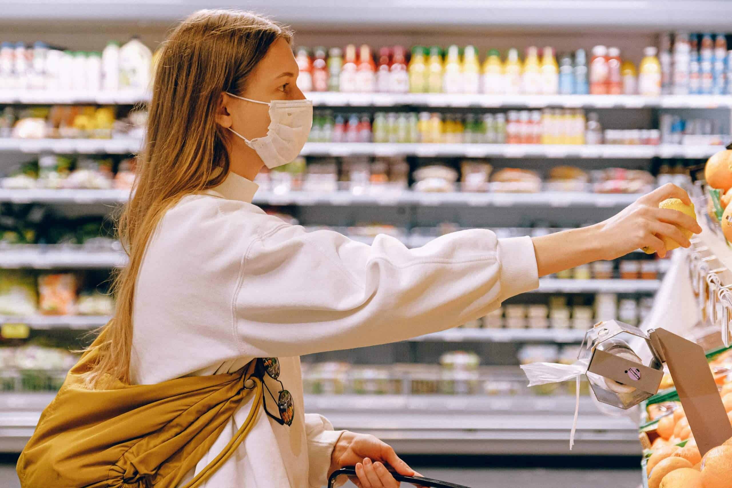 Woman Picking Up Produce