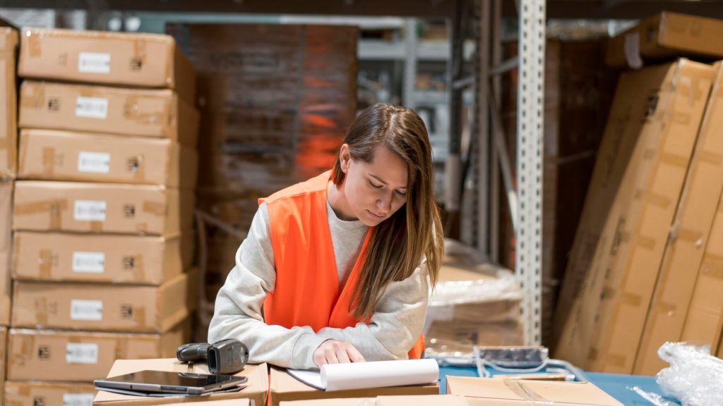 in warehouse female employee checking files